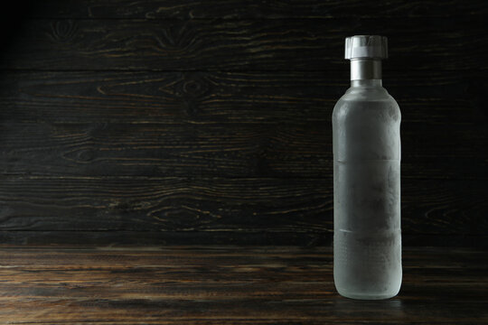 Blank Bottle Of Vodka On Wooden Background, Space For Text