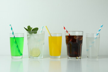 Glasses of different soda isolated on white background