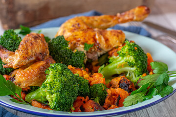 Broccoli and sweet potatoes served as a side dish with chicken