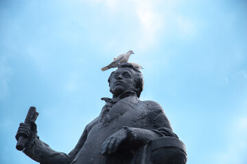 The dove sits on the head of the monument to Pushkin.