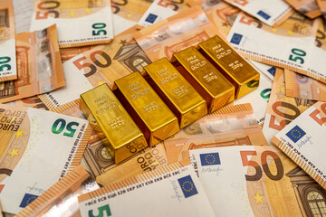  Big amount of money banknotes and gold bullion saving concept