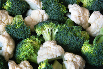 Pieces of ripe broccoli and cauliflower. Healthy background
