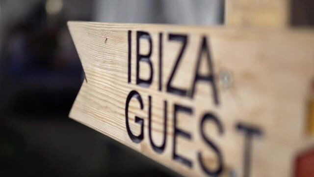 Ibiza guest wooden sign at night