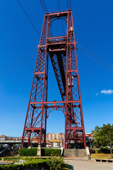 Fototapeta na wymiar View of metal support tower of Vizcaya ferry Bridge on Nervion river bank in Portugalete, Spain