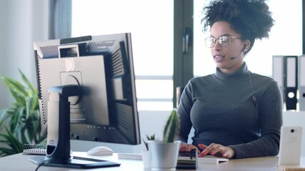 Video of beautiful young afro business woman working while making video call with computer sitting in the office. - Powered by Adobe