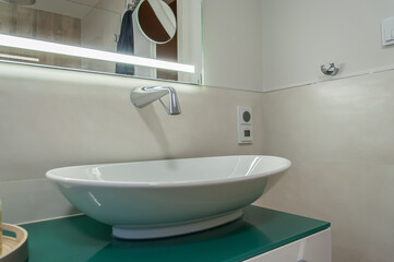 Detail of a vanity unit. Sink mounted on a cabinet, with a wall tap. Detail einer Waschtischanlage mit einer Wandarmatur