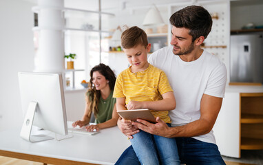 Happy modern family using computer together at home