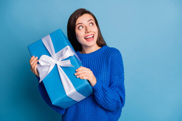 Photo of young lovely dreamy attractive cheerful girl smiling look copyspace hold christmas gift...