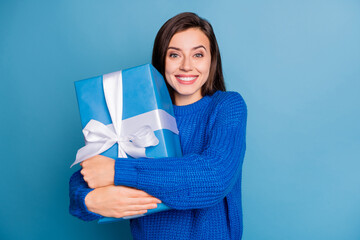 Fototapeta premium Photo of young lovely pretty good mood positive girl smiling hug big present isolated on blue color background