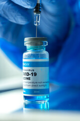 Medical concept ampoules or vials with Covid-19 vaccine on a laboratory bench