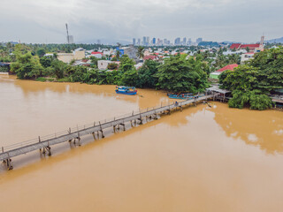 Fototapeta premium Aerial view of old wooden bridge over the river. Drone