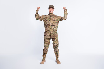 Full size photo of young woman soldier officer army show hand biceps power strong isolated over...