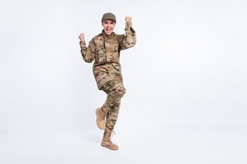 Full size photo of young woman soldier happy positive smile rejoice win victory fists hands isolated over white color background