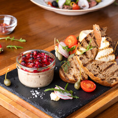 Meat pate with cranberry sauce and crispy bread