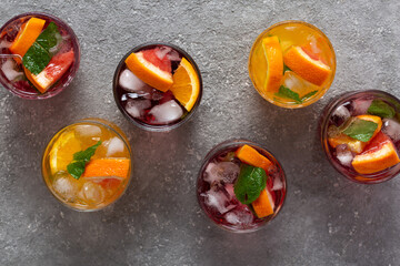 Alcoholic cocktails with ice and fruit at the bar. top view
