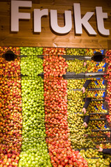 Stockholm, Sweden A large mirrored display of fruit in a supermarket and a saying saying Frukt in Swedish.