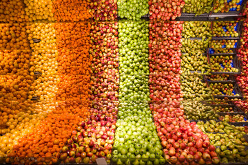 Stockholm, Sweden A large mirrored display of fruit in a supermarket and a saying saying Frukt in...