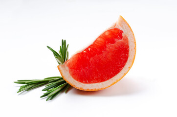 Closeup of slice of fresh juicy grapefruit and green rosemary on the white background