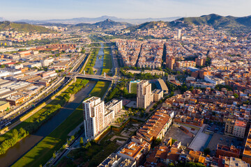 Fototapeta na wymiar Aerial urban landscape of Santa Coloma de Gramenet municipality and Besos river, Catalonia, Spain