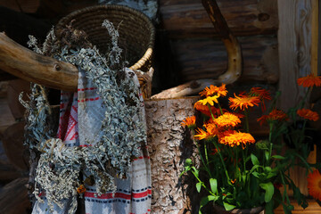 A wreath of useful herbs is being dried on a tree.