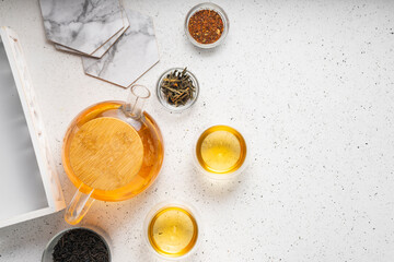 Obraz na płótnie Canvas light tea flatley. pour black tea into thermos cups, on a light background. tea ceremony with different types of leaf tea