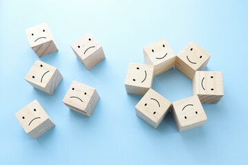 Concept image of satisfaction level. wooden cubes with emotions