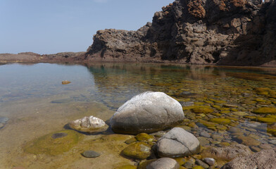 Gran Canaria, calm natural seawater pools in under the steep cliffs of the north coast and separated from the ocean by volcanic rocks,
Sardina del Norte area
