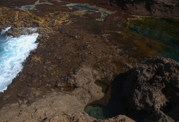 Gran Canaria, calm natural seawater pools in under the steep cliffs of the north coast and separated from the ocean by volcanic rocks,
Sardina del Norte area
