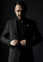 Portrait of a handsome man in black suit indoor