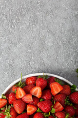 Ripe delicious strawberries on a white plate, top view