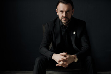 Portrait of a handsome man in black suit indoor - 417321994