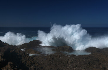 Fototapeta na wymiar Gran Canaria, north coast, area around Punta Sardina cape, powerful foamy ocean waves breaking along the shore 