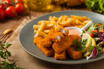 Fish sticks with fries and salad.