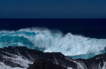 Gran Canaria, north coast, area around Punta Sardina cape, powerful foamy ocean waves breaking along the shore
