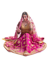 Beautiful young female Bollywood dancer in traditional bright pink wedding dress