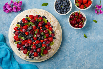 Meringue Pavlova cake with fresh fruit. Top view.