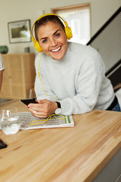 Blond woman listening music at home