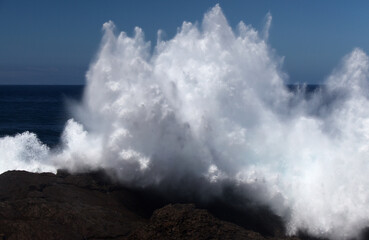 Gran Canaria, north coast, area around Punta Sardina cape, powerful foamy ocean waves breaking along the shore

