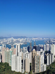 Vertical shot of the beautiful view of coastline skyscrapers under the clear sky in Hong Kong