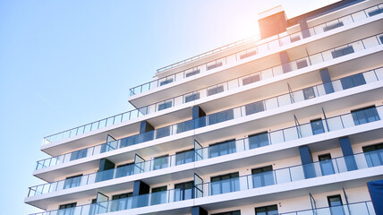 Fototapeta premium Apartment residential house and home facade architecture and outdoor facilities. Blue sky on the background. Sunlight in sunrise.