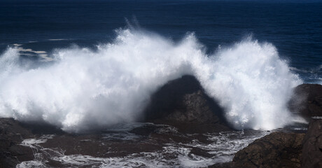 Gran Canaria, north coast, area around Punta Sardina cape, powerful foamy ocean waves breaking along the shore
