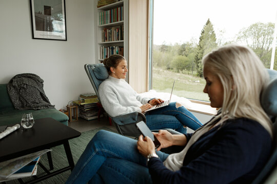 Two women relaxing in living room