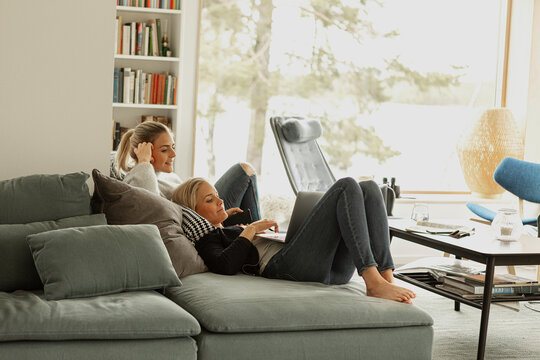 Two women relaxing in living room