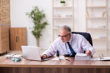 Old businessman employee in budget planning concept