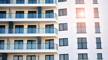 Fototapeta na wymiar Apartment residential house and home facade architecture and outdoor facilities. Blue sky on the background. Sunlight in sunrise.