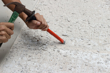 A mechanic was hammering a chisel into the floor 2