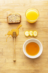 Still life with a piece of banana bread, honey, banana and orange juice. American cuisine. Zero waste. A way to make ripe bananas. Not wasting food.