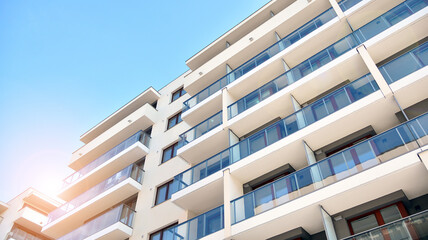 Fototapeta premium Apartment residential house and home facade architecture and outdoor facilities. Blue sky on the background. Sunlight in sunrise.