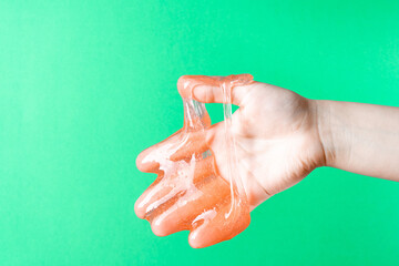 The handshake. Slime spreads on the fingers on a green background