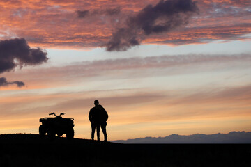 Obraz na płótnie Canvas Silhouette ATV or Quad bike in the sunset. Holiday exploration concept